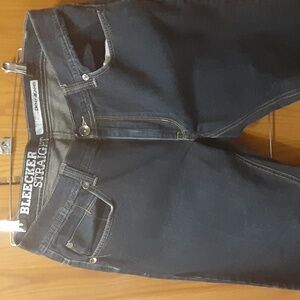 A pair of dkny blue jeans